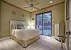 Beach style decorated guest bedroom with sliding doors to the screened in pool area.