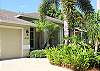 Inviting entrance with lush landscaping to this vacation home