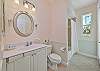 The guest bathroom with a shower-tub combination, is also accessible from the pool area