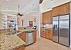 Fully equipped kitchen with stainless steel appliances and granite counter-tops