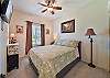 A Queen bed and flat screen TV in the guest bedroom