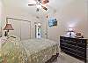 A Queen bed and flat screen TV in the guest bedroom