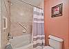 Dual sinks and a shower tub combo in the master bathroom