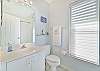 The guest bathroom features a shower-tub combo