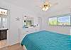 The guest bedroom features a queen size bed