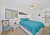 The guest bedroom features a queen size bed