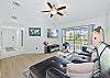 Living with smart TV & cable and sliding doors opening to the large screened in balcony.
