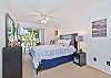 The master bedroom is equipped with a queen size bed and smart TV with cable