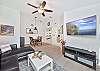 Living with smart TV & cable and sliding doors opening to the large screened in balcony.