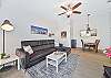 Living with smart TV & cable and sliding doors opening to the large screened in balcony.