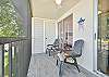 Sliding doors from the living and primary bedroom open up to the oversized screened in balcony.