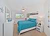 The guest bedroom features a queen size bed