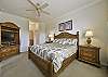 The master suite is equipped with a king size bed and flat screen TV.