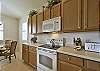 Fully equipped gourmet kitchen with breakfast bar and dining.