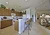 Fully equipped gourmet kitchen with breakfast bar and dining.