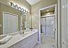 The en-suite master bathroom is equipped with a spacious walk-in shower
