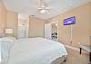 The primary bedroom features a king size bed, flat screen TV and en-suite bathroom. 