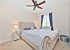 A queen size bed in the guest bedroom.