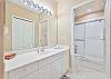 The en-suite master bathroom is equipped with a spacious walk-in shower