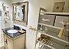 The  guest bathroom offers a shower tub combo