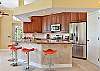 Fully equipped open kitchen with large breakfast bar, dining area with wet bar and additional seating area