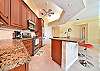 Fully equipped open kitchen with large breakfast bar, dining area with wet bar and additional seating area