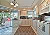 Fully equipped kitchen with sliding door to the screened in patio