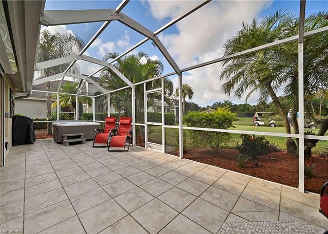 The screened in patio offers a covered dining area, seating and lounging area and a hot tub.