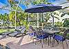 Screened in pool area with outdoor dining, lounge area and seating and outdoor kitchen at the covered lanai