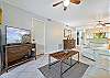 Family room with recliner sofa and chair, a flat screen TV and sliding doors to the screened in lanai and porch.