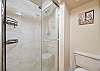 The en-suite master bathroom features a walk-in shower