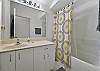 The guest bathroom features a shower-tub combo