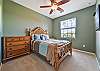 A queen size bed and flat screen TV in the guest bedroom