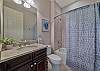 A shower-tub combo in the guest bathroom. A pocket door can close off the hallway to the guest bedroom and bathroom and make it into a second master suite