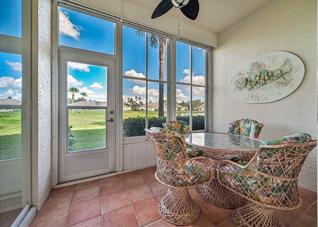 The glassed- and screened in lanai off the living and master bedroom offers lake view