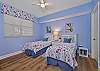 The third bedroom features two twin beds and an en-suite bathroom