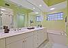 The en-suite master bathroom features double sinks and separate tub and shower.