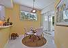 Breakfast nook with sliding doors opening to the screened in lanai and terrace