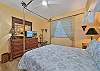 A queen size bed and flat screen smart TV in the guest bedroom