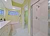 The en-suite master bathroom features double sinks and separate tub and shower.