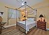 A queen size bed and flat screen smart TV in the guest bedroom