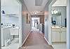 Upstairs hallway with the guest bathroom to the right and the laundry room to the left.