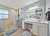 En-suite primary bathroom with separate sinks and a spacious walk-in shower