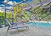Screened in pool area with heated pool. The large steps which double as a tanning ledge. 