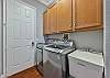 In house laundry room with washer & dryer and sink