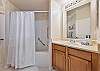 A shower-tub combo in the guest bathroom