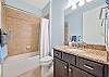 A shower-tub combo in the guest bathroom