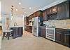 Fully equipped kitchen with island and bar area with beverage center