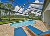 The screened in pool area offers lake and preserve view