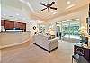 Family room off the kitchen with sliding door opening to the screened in pool area